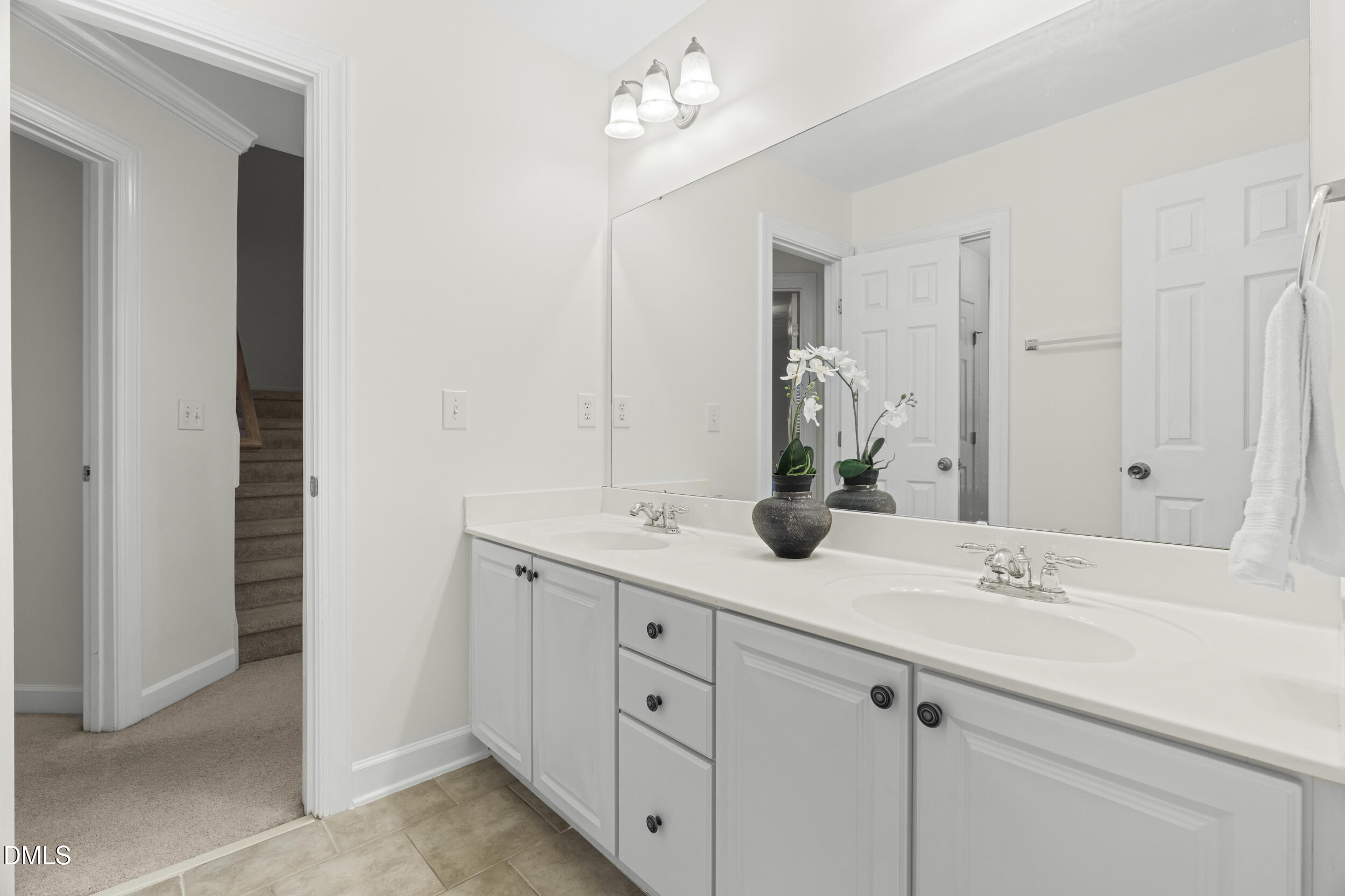 105 Bayless Ridge Court Morrisville, NC 27560 - Photo 33 of 42 a bathroom with a double vanity sink and a mirror