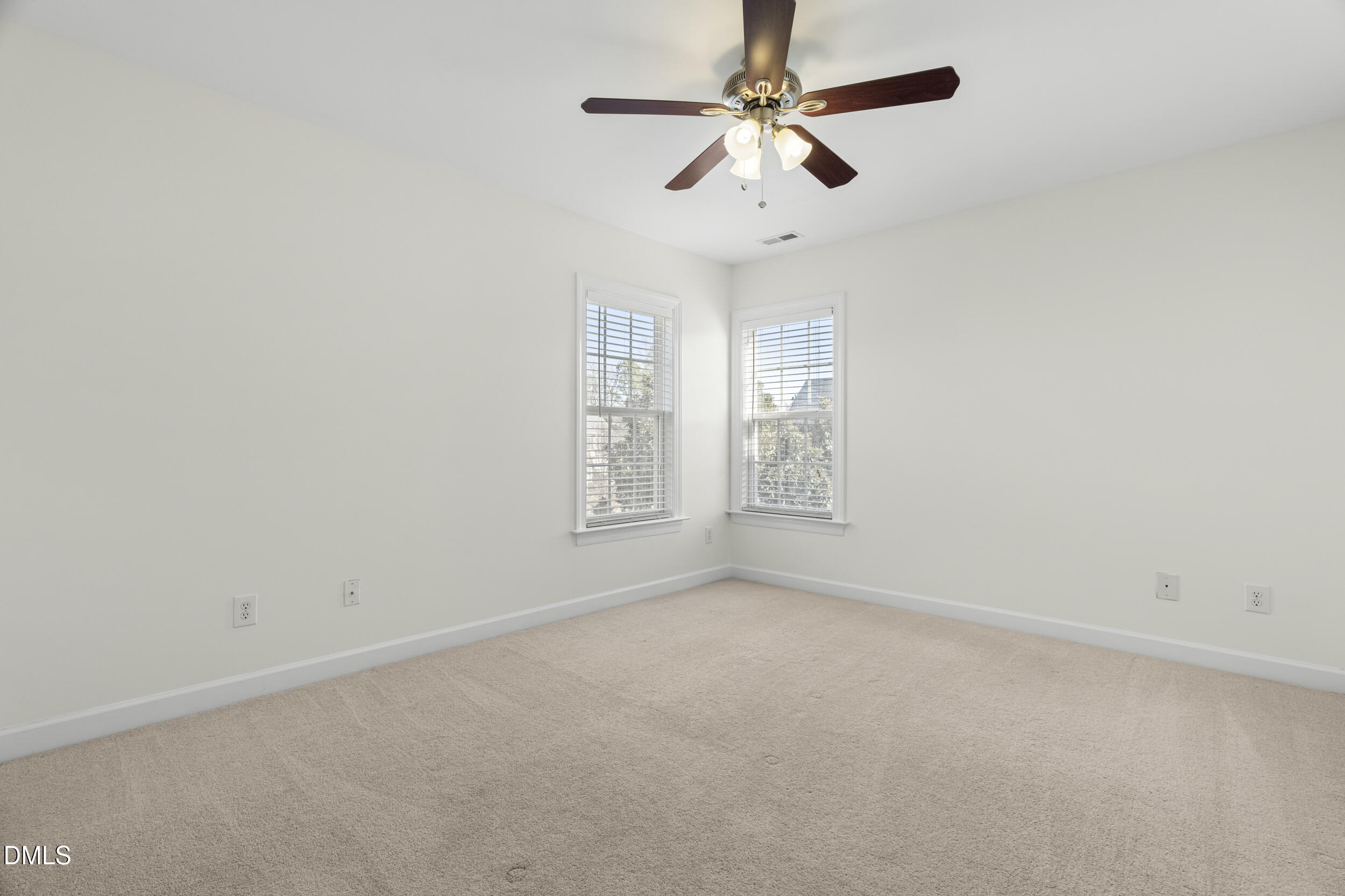 105 Bayless Ridge Court Morrisville, NC 27560 - Photo 35 of 42 en empty room with windows and ceiling fan