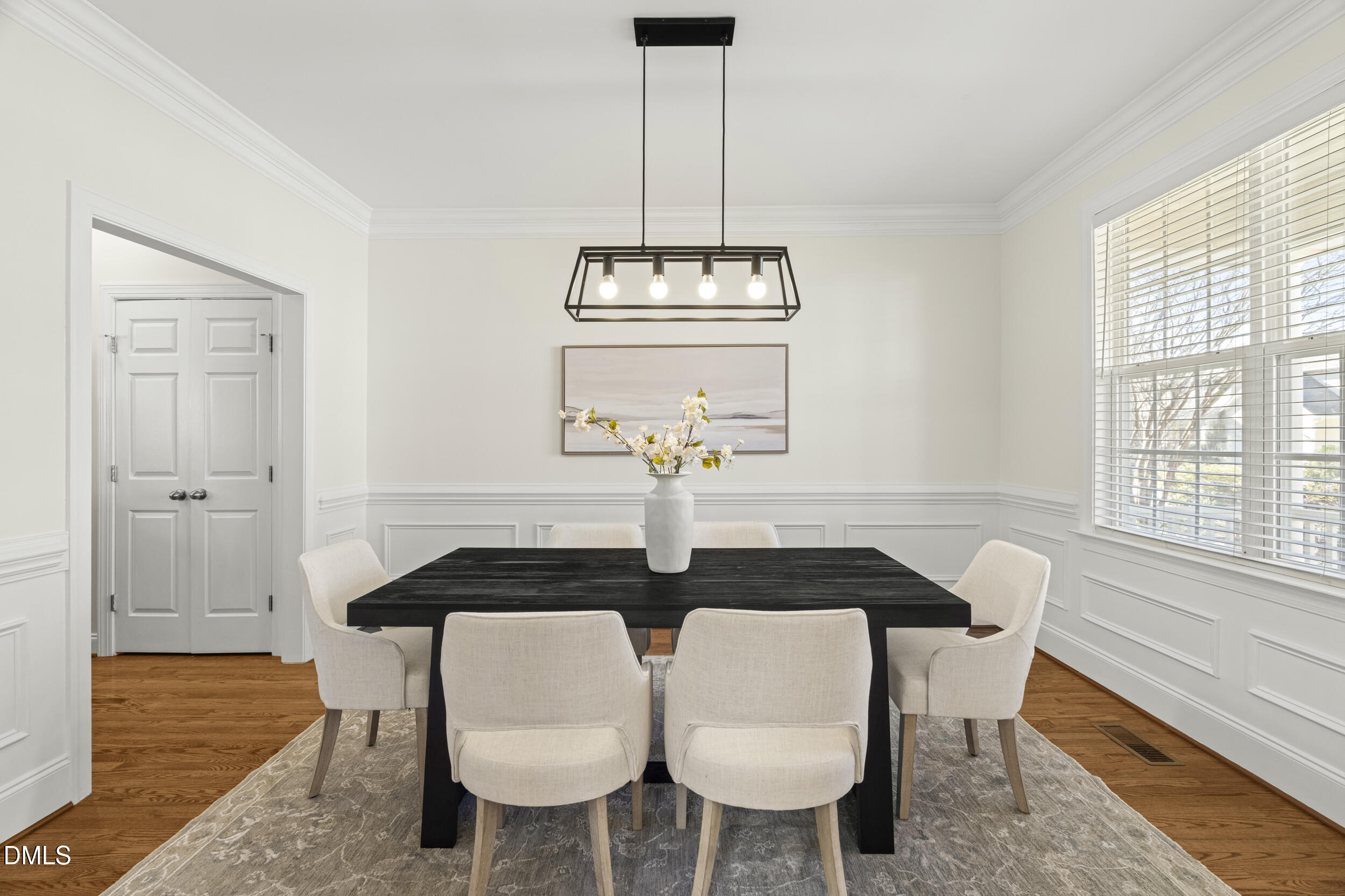 105 Bayless Ridge Court Morrisville, NC 27560 - Photo 10 of 43 a table with a vase and chandelier