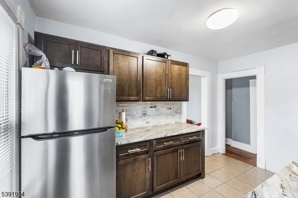 a kitchen with a refrigerator sink and cabinets