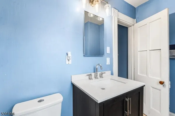 a bathroom with a sink a toilet and a mirror