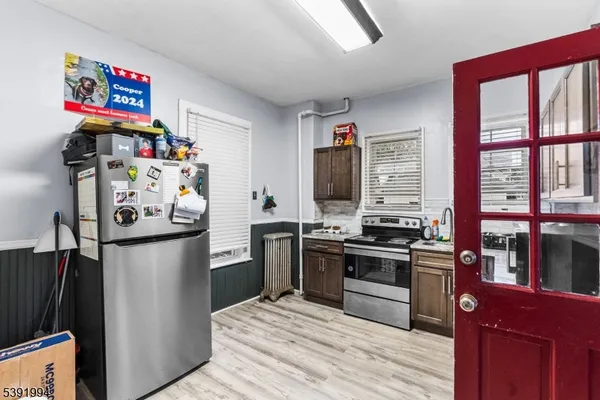 a kitchen with stainless steel appliances granite countertop a refrigerator and a stove