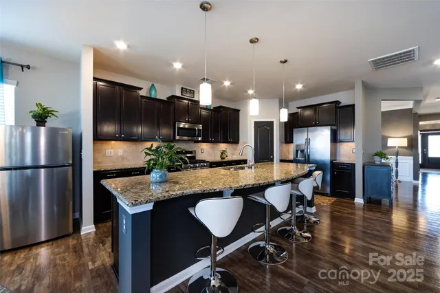 a large kitchen with a table and chairs