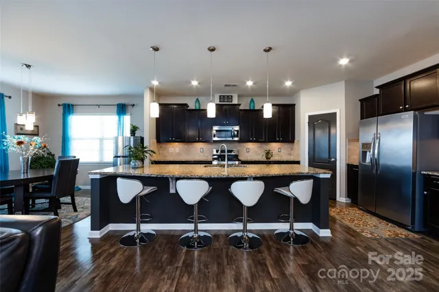 a kitchen with granite countertop stainless steel appliances and wooden cabinets