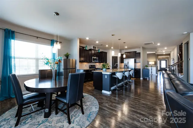 a dining room with furniture window and wooden floor
