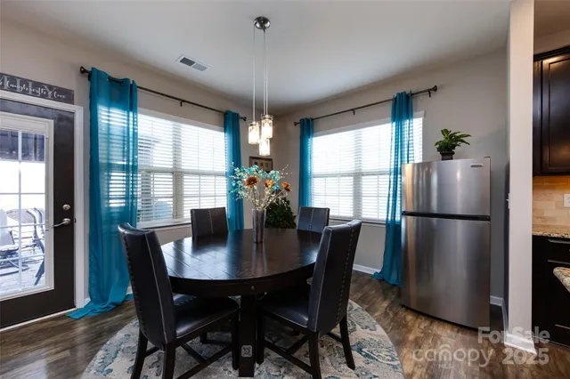 a view of a dining room with furniture and window