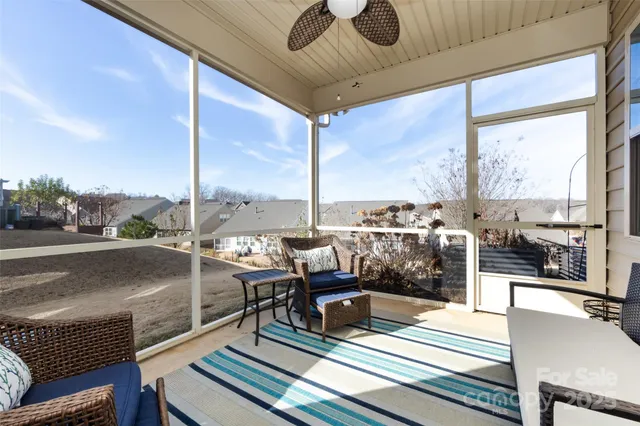 a living room with furniture and a floor to ceiling window