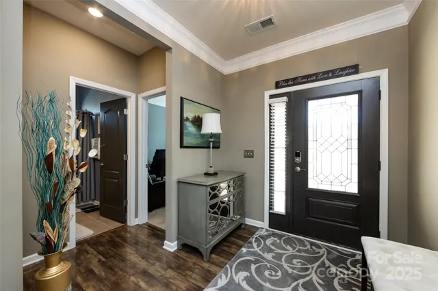 a view of a hallway with furniture and front door