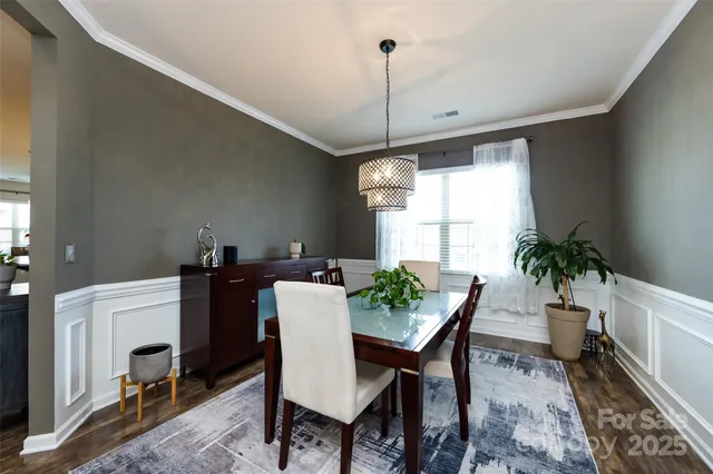 a view of a dining room with furniture and chandelier