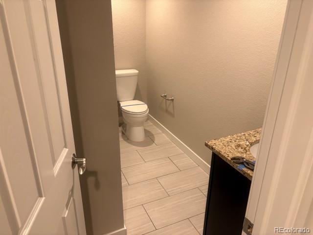 3290 Magnolia Street Denver, CO 80207 - Photo 11 of 15 a bathroom with a granite countertop sink and a toilet