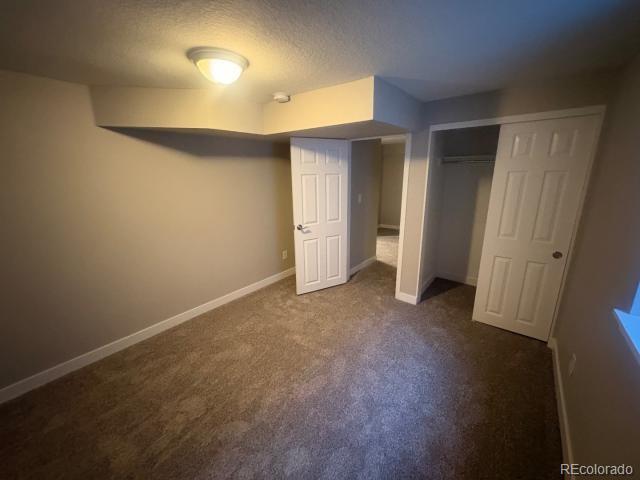 3290 Magnolia Street Denver, CO 80207 - Photo 13 of 15 an empty room with closet and mirror