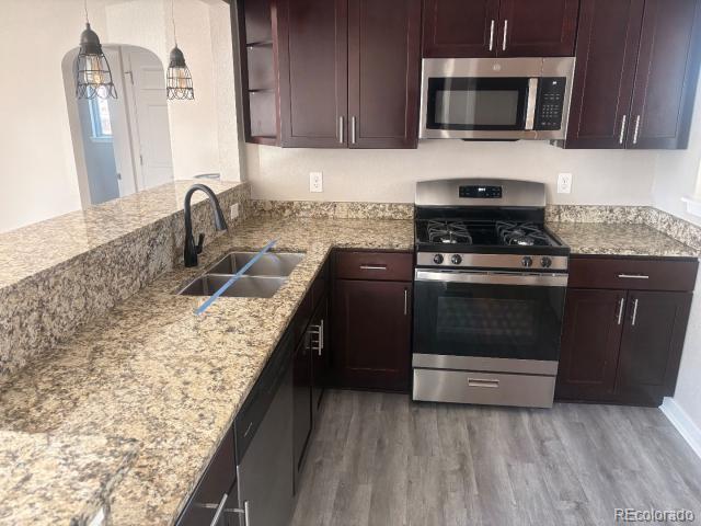 3290 Magnolia Street Denver, CO 80207 - Photo 3 of 15 a kitchen with a stove and a microwave