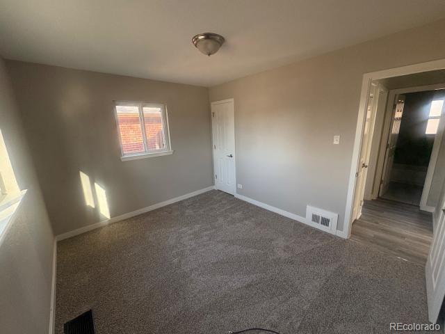 3290 Magnolia Street Denver, CO 80207 - Photo 5 of 15 an empty room with windows