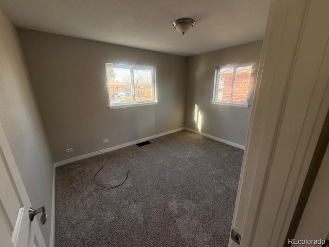 3290 Magnolia Street Denver, CO 80207 - Photo 7 of 15 a view of an empty room with a window