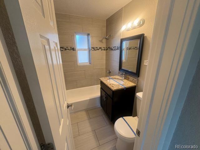 3290 Magnolia Street Denver, CO 80207 - Photo 9 of 15 a bathroom with a granite countertop sink toilet and shower