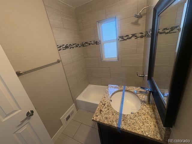 3290 Magnolia Street Denver, CO 80207 - Photo 10 of 15 a bathroom with a granite countertop sink and a mirror