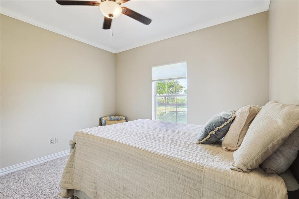 3289 Mitchell Road Krum, TX 76249 - Photo 21 of 38 a bedroom with a bed and a window