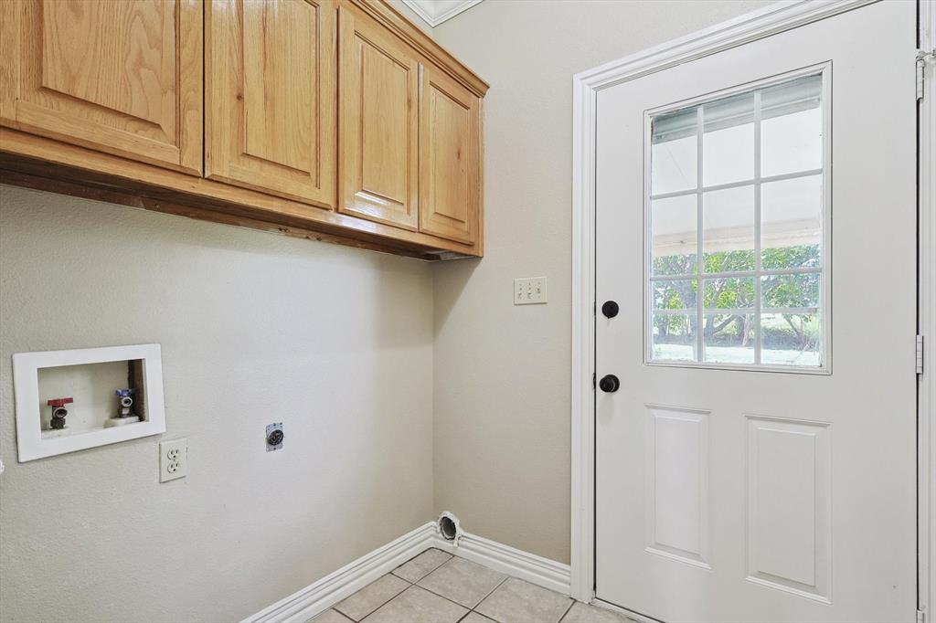 3289 Mitchell Road Krum, TX 76249 - Photo 22 of 38 a view of cabinets and window