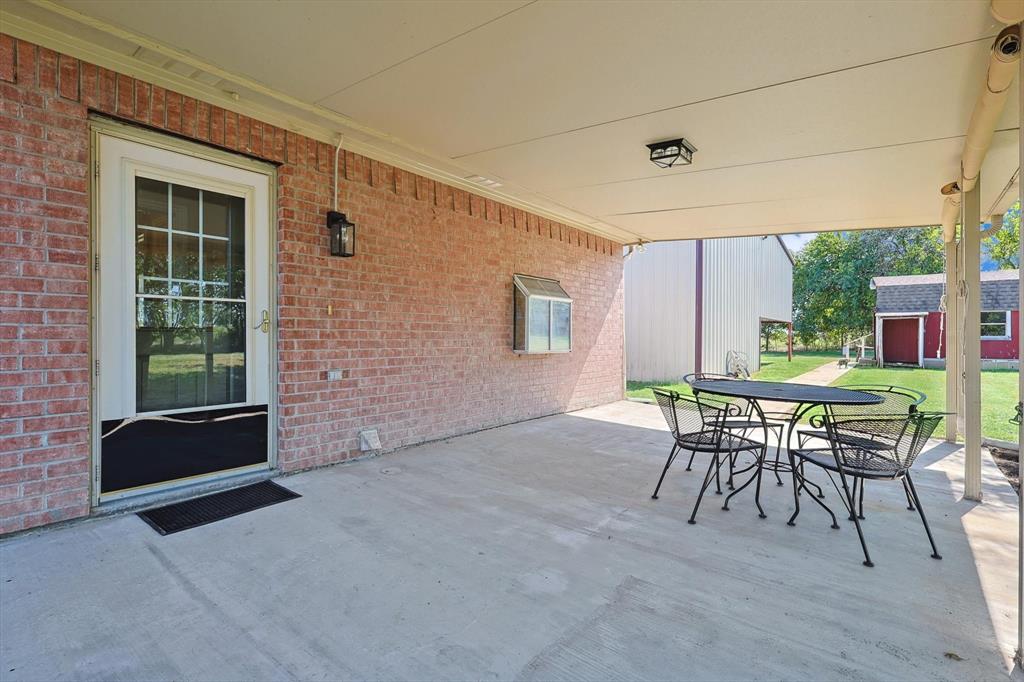 3289 Mitchell Road Krum, TX 76249 - Photo 24 of 38 a patio with yard table and chairs