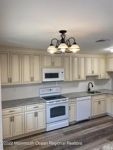 a kitchen with cabinets a sink and appliances