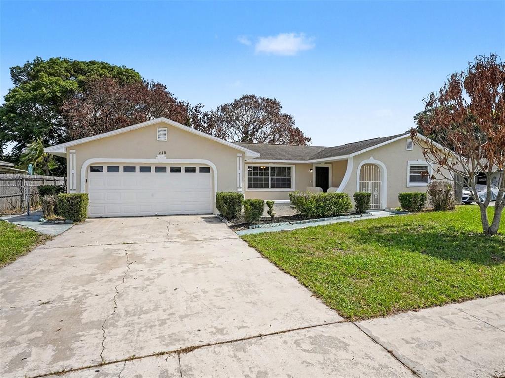 615 Thomas Jefferson Way Orlando, FL 32809 - Photo 1 of 17 a front view of a house with a yard
