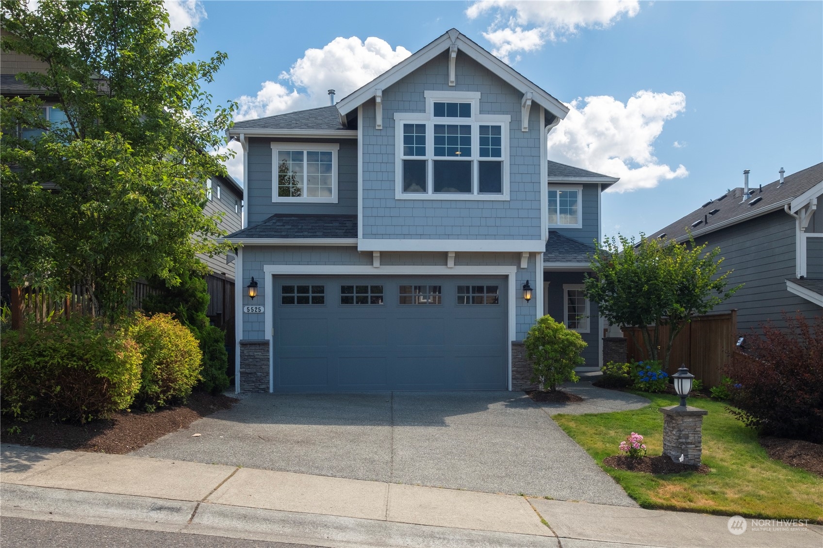 5525 Northeast 7th Place Renton, WA 98059 - Photo 1 of 30 a front view of a house with a yard and garage