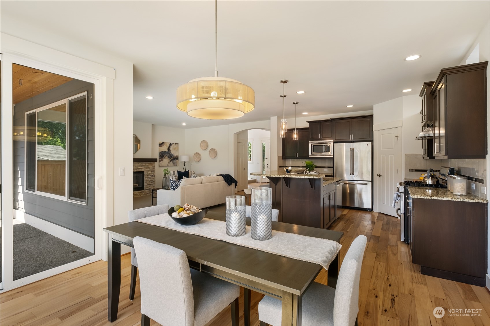 5525 Northeast 7th Place Renton, WA 98059 - Photo 11 of 30 a kitchen with stainless steel appliances wooden floor dining table and chairs