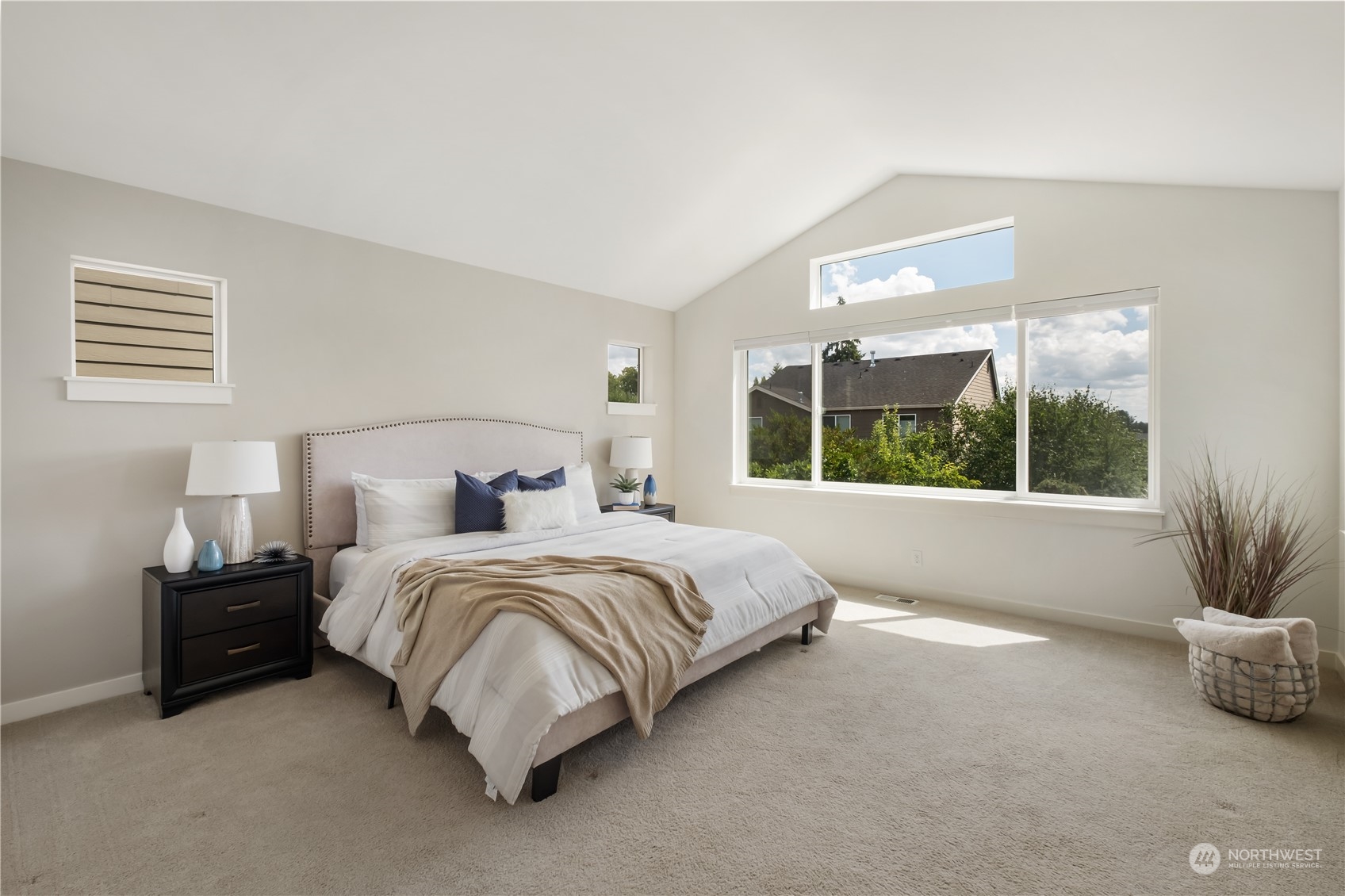 5525 Northeast 7th Place Renton, WA 98059 - Photo 15 of 30 a spacious bedroom with a bed and a large window