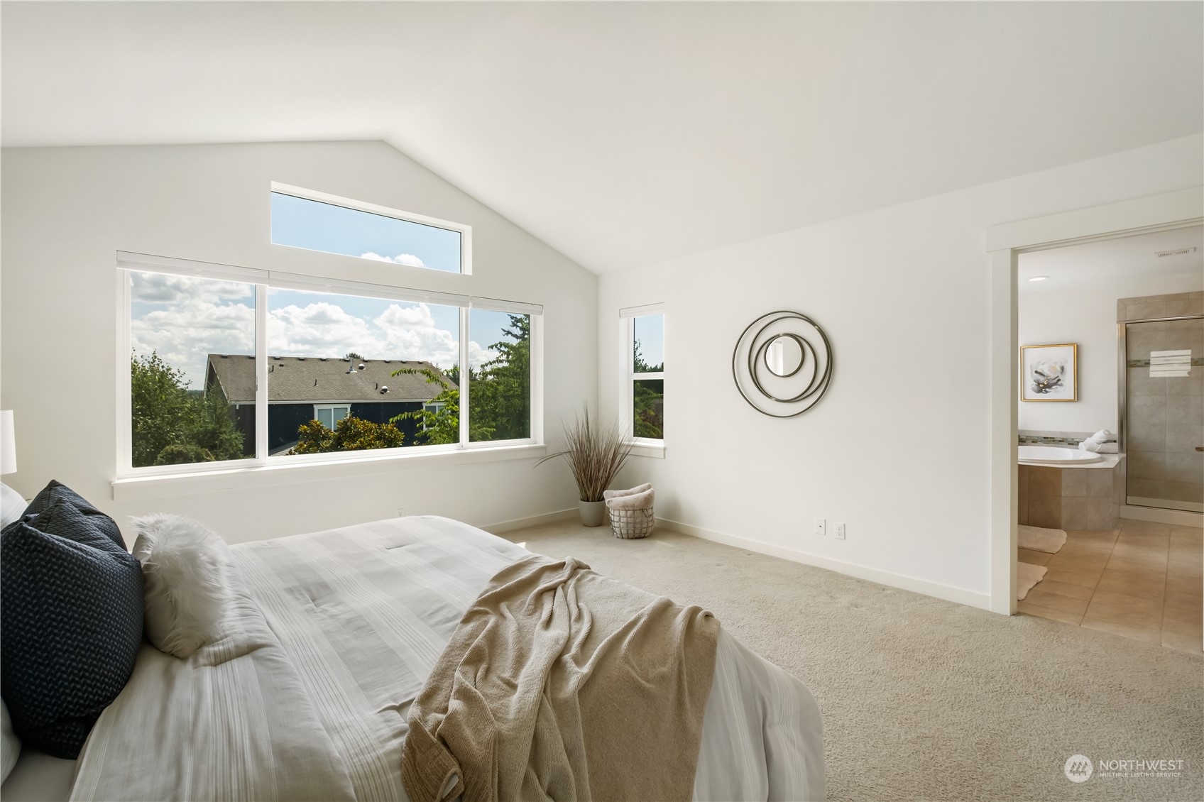 5525 Northeast 7th Place Renton, WA 98059 - Photo 16 of 30 a bed sitting in a bedroom next to a window