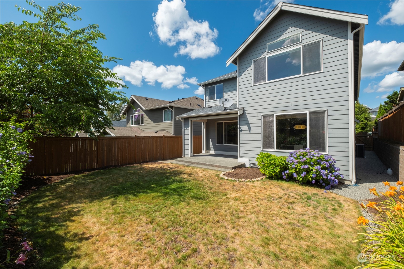 5525 Northeast 7th Place Renton, WA 98059 - Photo 29 of 30 a front view of a house with a yard and garage