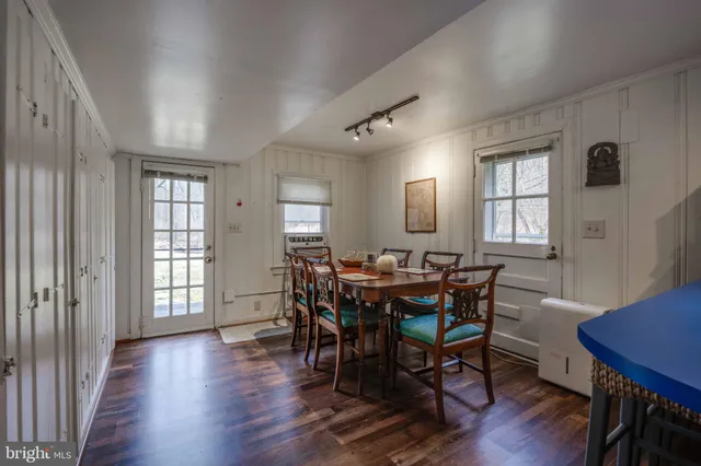 a view of a a dining room with furniture and window
