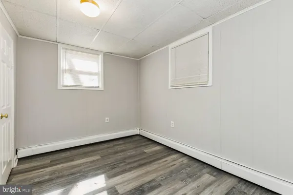 a view of an empty room with a fireplace and a window