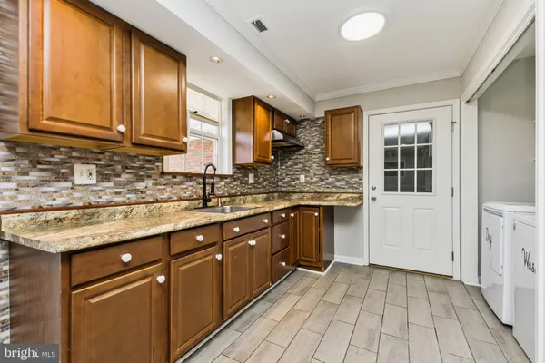 a kitchen with stainless steel appliances granite countertop a sink and cabinets