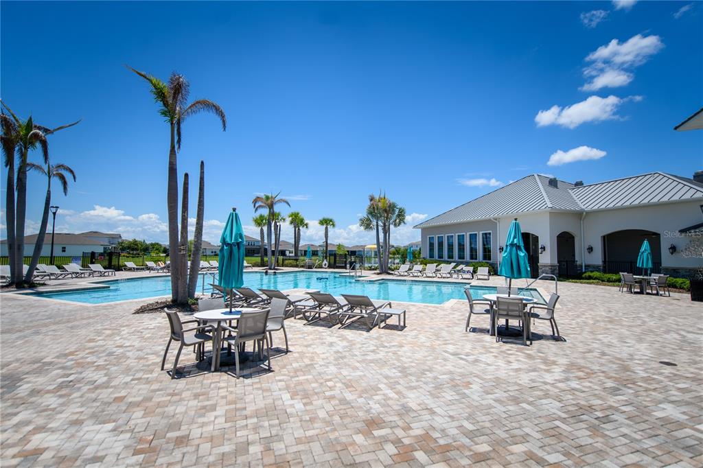 10746 Pahokee Beach Place Orlando, FL 32827 - Photo 61 of 67 a view of a patio with a dining table and chairs with a patio