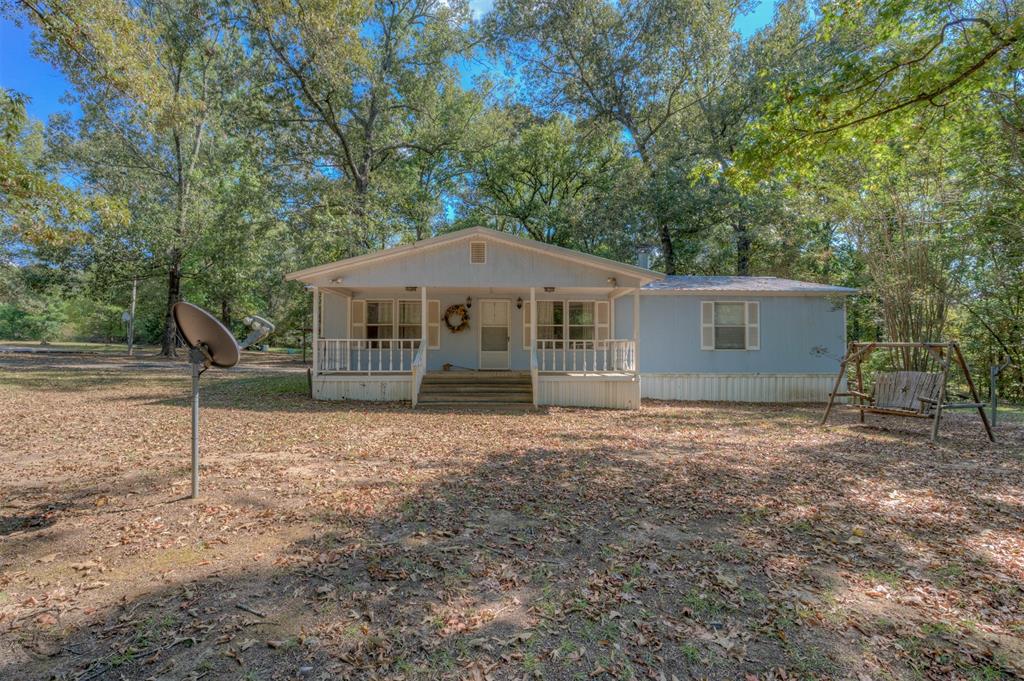 8839 Sebastian Road Keithville, LA 71047 - Photo 23 of 40 Single-story residence with a covered front porch featuring white railings and columns