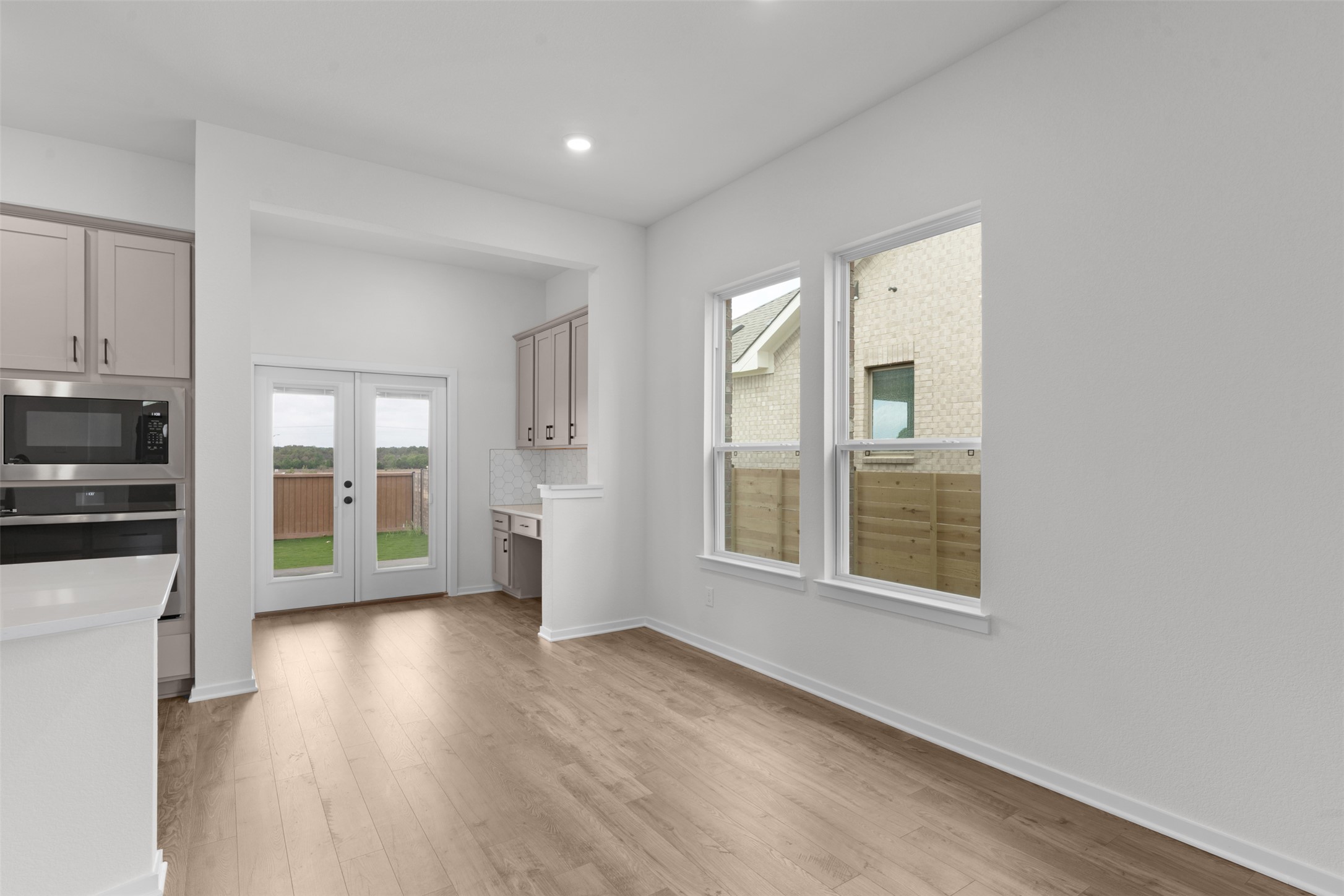 405 Raleigh Drive Georgetown, TX 78633 - Photo 7 of 27 Unfurnished dining area featuring light wood finished floors, french doors, and recessed lighting