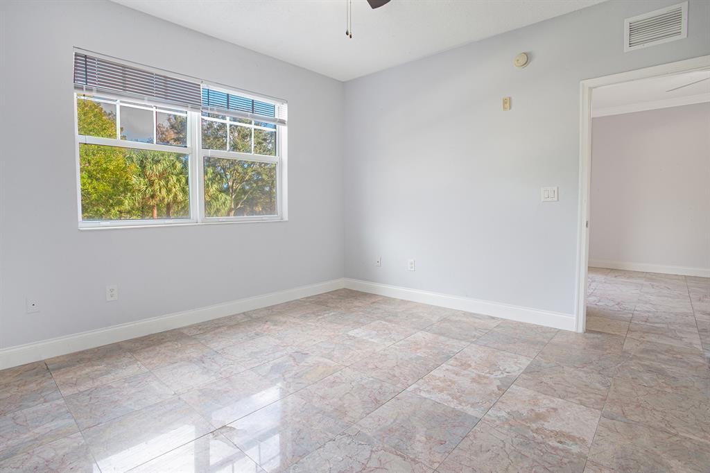 5860 West Sample Road, Unit 204 Coral Springs, FL 33067 - Photo 22 of 36 an empty room with windows