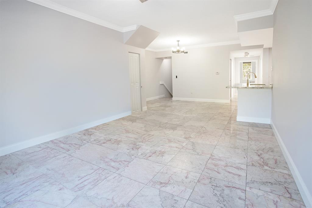 5860 West Sample Road, Unit 204 Coral Springs, FL 33067 - Photo 5 of 36 a view of a big room with wooden floor and a kitchen