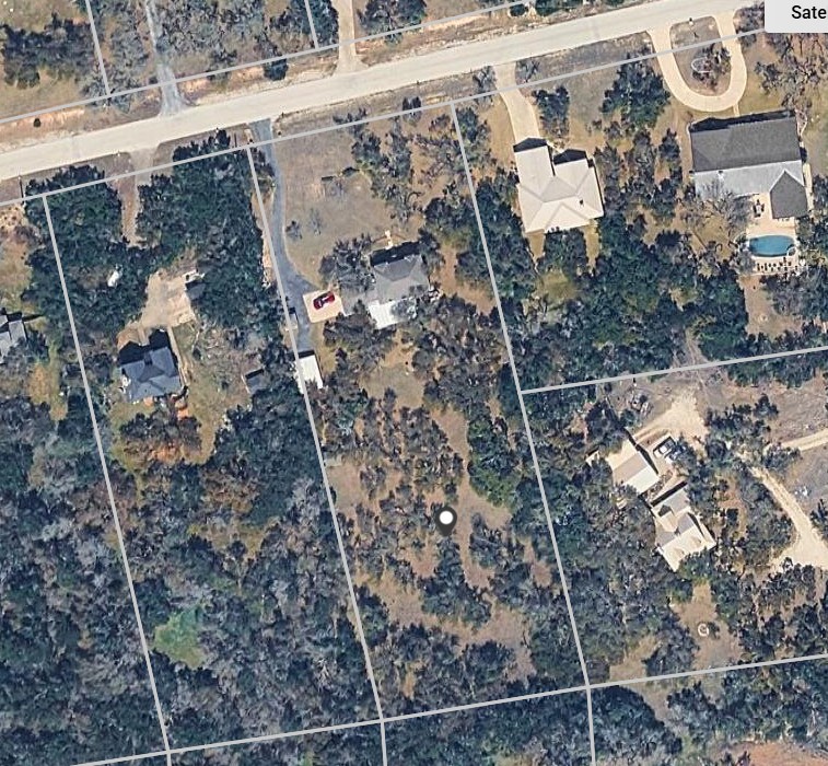 1003 Pier Branch Road Dripping Springs, TX 78620 - Photo 9 of 40 An aerial perspective reveals a generously proportioned lot, dotted with established trees, offering ample space for a custom home.