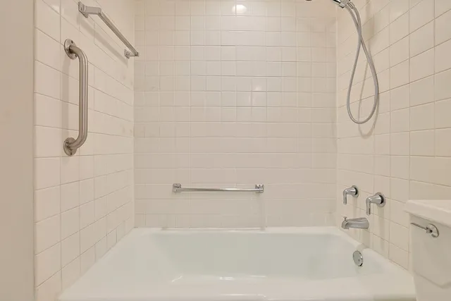 a bathroom with a toilet sink vanity and mirror