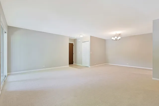 a view of an empty room with a kitchen