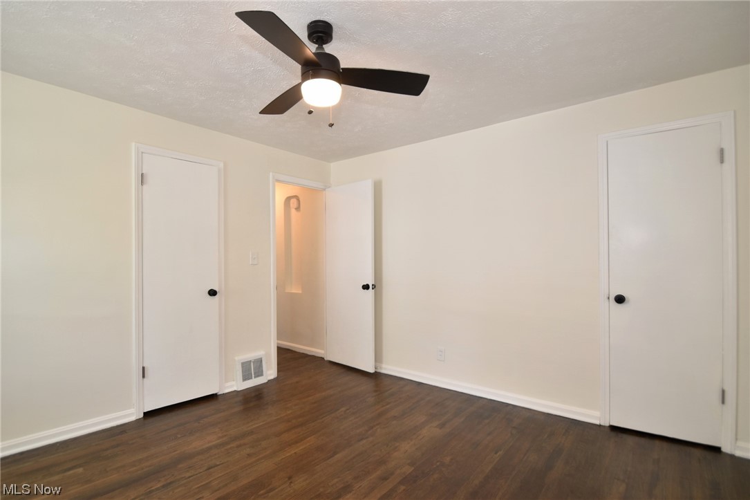 1259 Churchill Road Cleveland, OH 44124 - Photo 14 of 24 Empty room with dark hardwood floors and ceiling fan