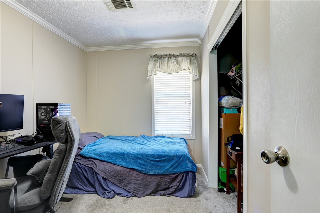 7820 Russell Street Sebastian, FL 32958 - Photo 20 of 36 a bedroom with a bed and a window