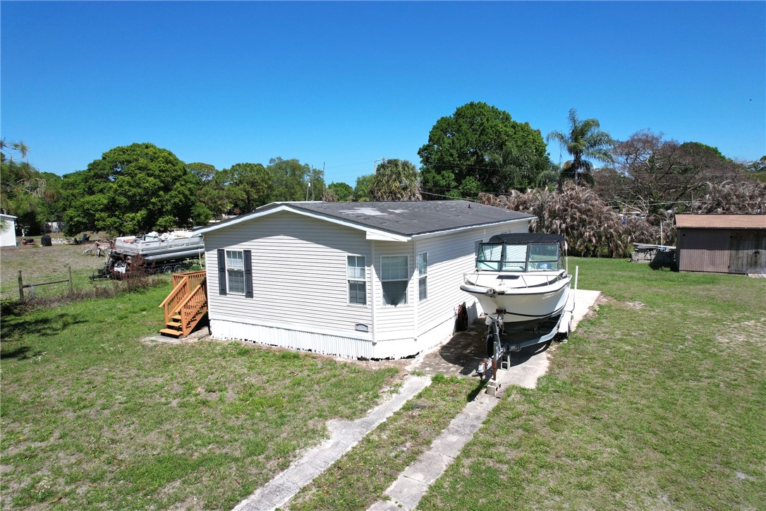 7820 Russell Street Sebastian, FL 32958 - Photo 2 of 36 a view of a house with backyard sitting area and garden