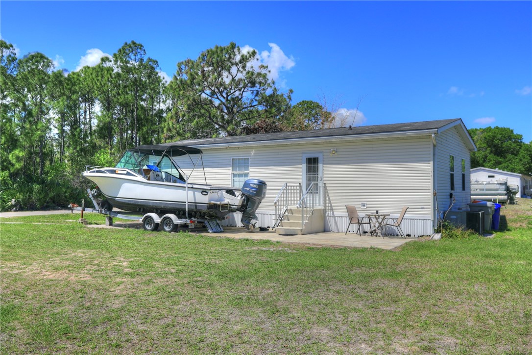 7820 Russell Street Sebastian, FL 32958 - Photo 27 of 36 a front view of a house with garden