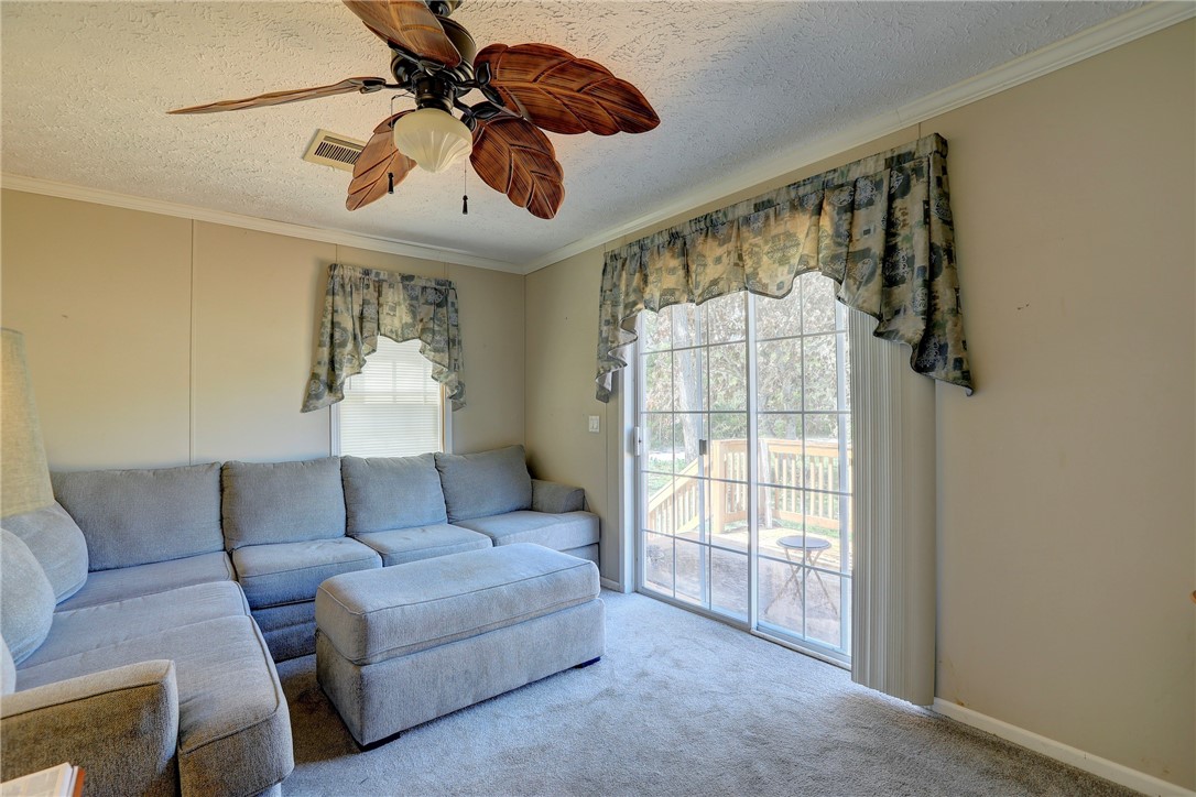 7820 Russell Street Sebastian, FL 32958 - Photo 6 of 36 a living room with furniture and a chandelier