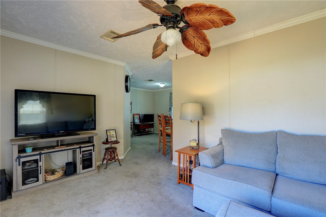 7820 Russell Street Sebastian, FL 32958 - Photo 7 of 36 a living room with furniture and a flat screen tv