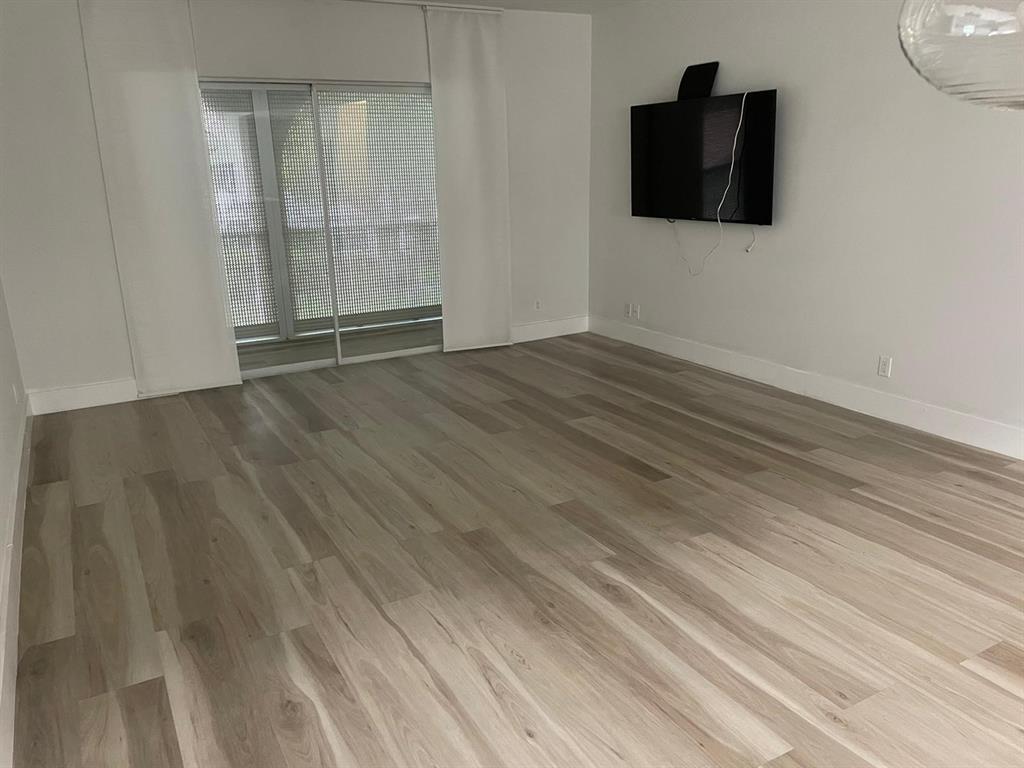250 Northeast 20th Street, Unit 210 Boca Raton, FL 33431 - Photo 14 of 50 a view of an empty room with wooden floor and a window
