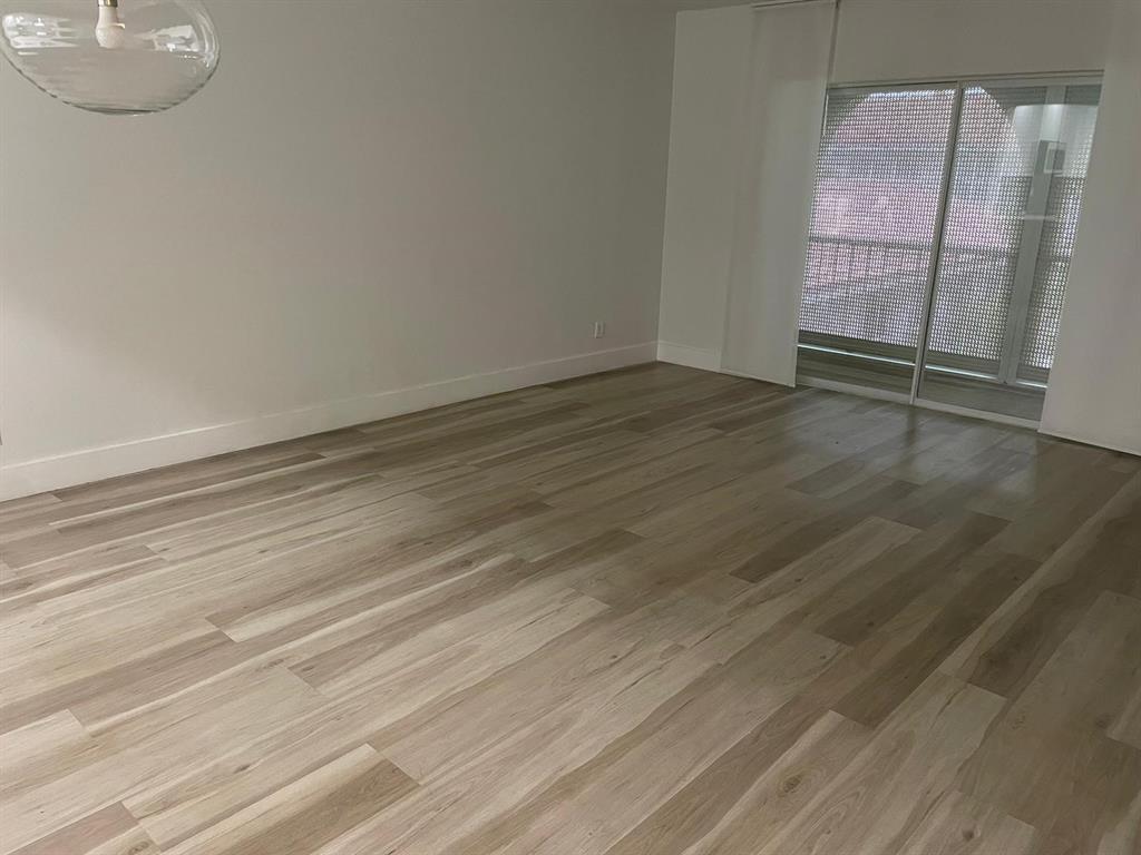 250 Northeast 20th Street, Unit 210 Boca Raton, FL 33431 - Photo 15 of 50 an empty room with wooden floor and mirror