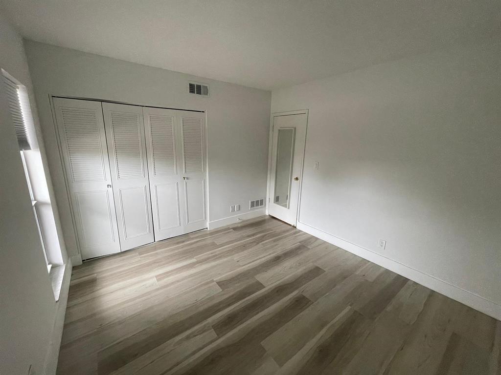 250 Northeast 20th Street, Unit 210 Boca Raton, FL 33431 - Photo 24 of 50 a view of empty room with wooden floor